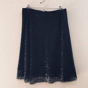Black sequin skirt, knee length a-line.